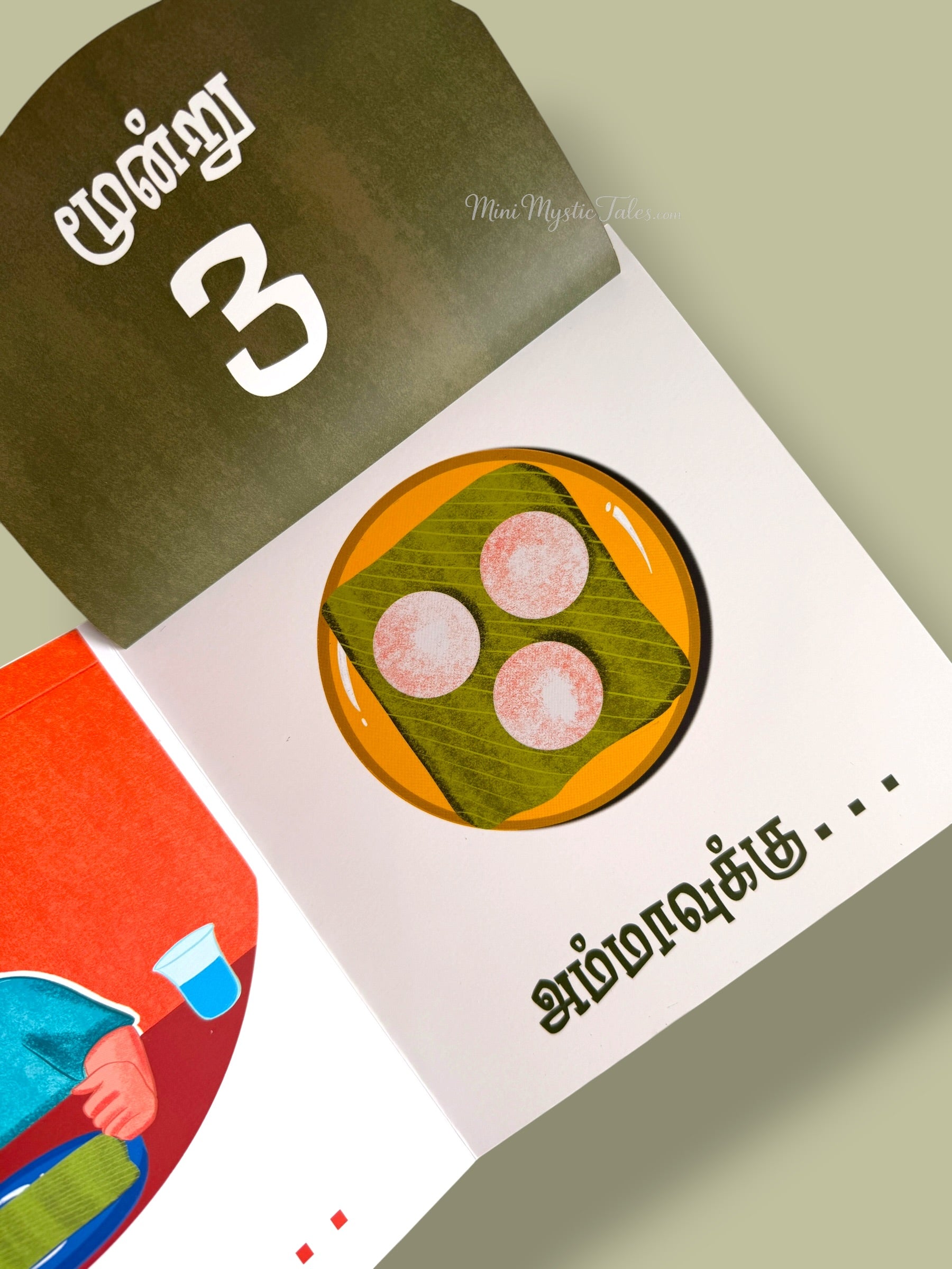 Illustrated Tamil learning book page showing three idlis served on a banana leaf for counting