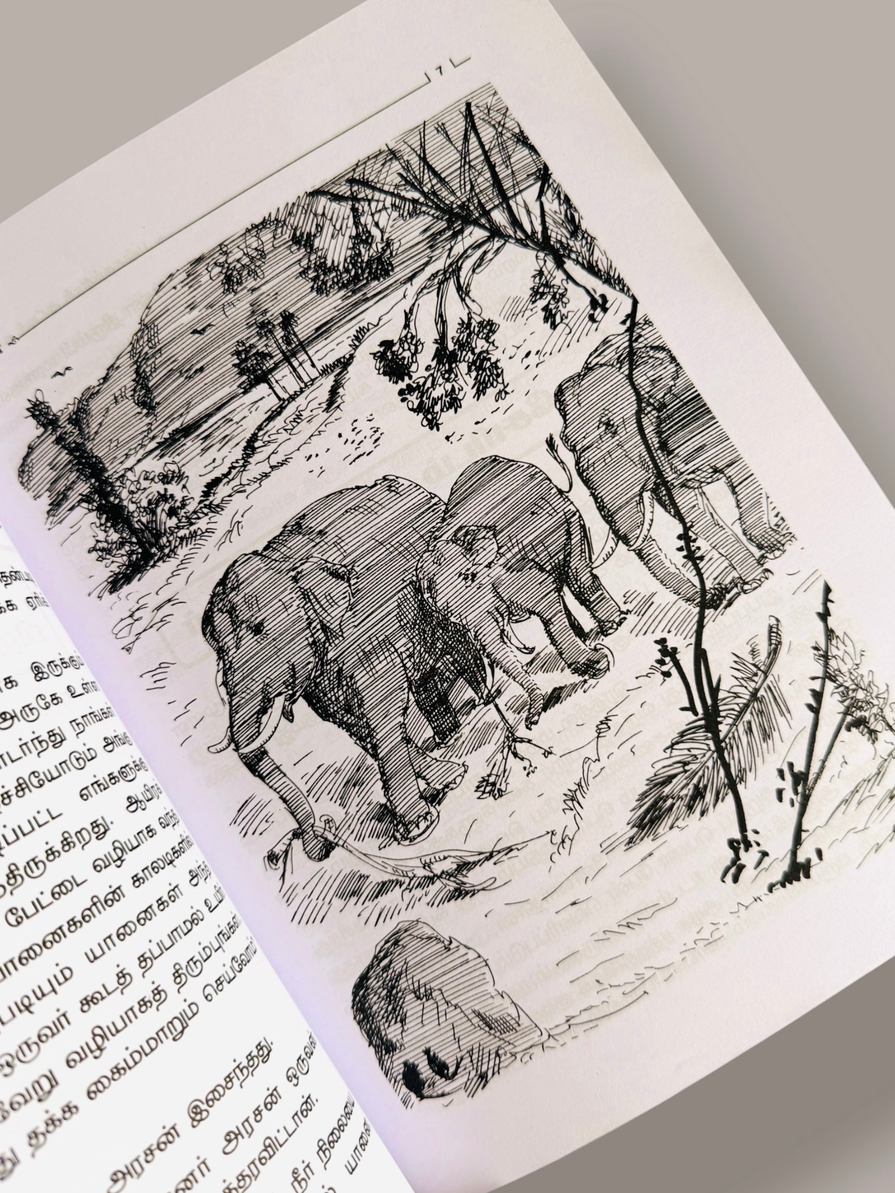 Illustration page from Panchatanthira Kutti Kadhaigal Tamil children’s story book featuring black and white elephant illustrations with Tamil story text