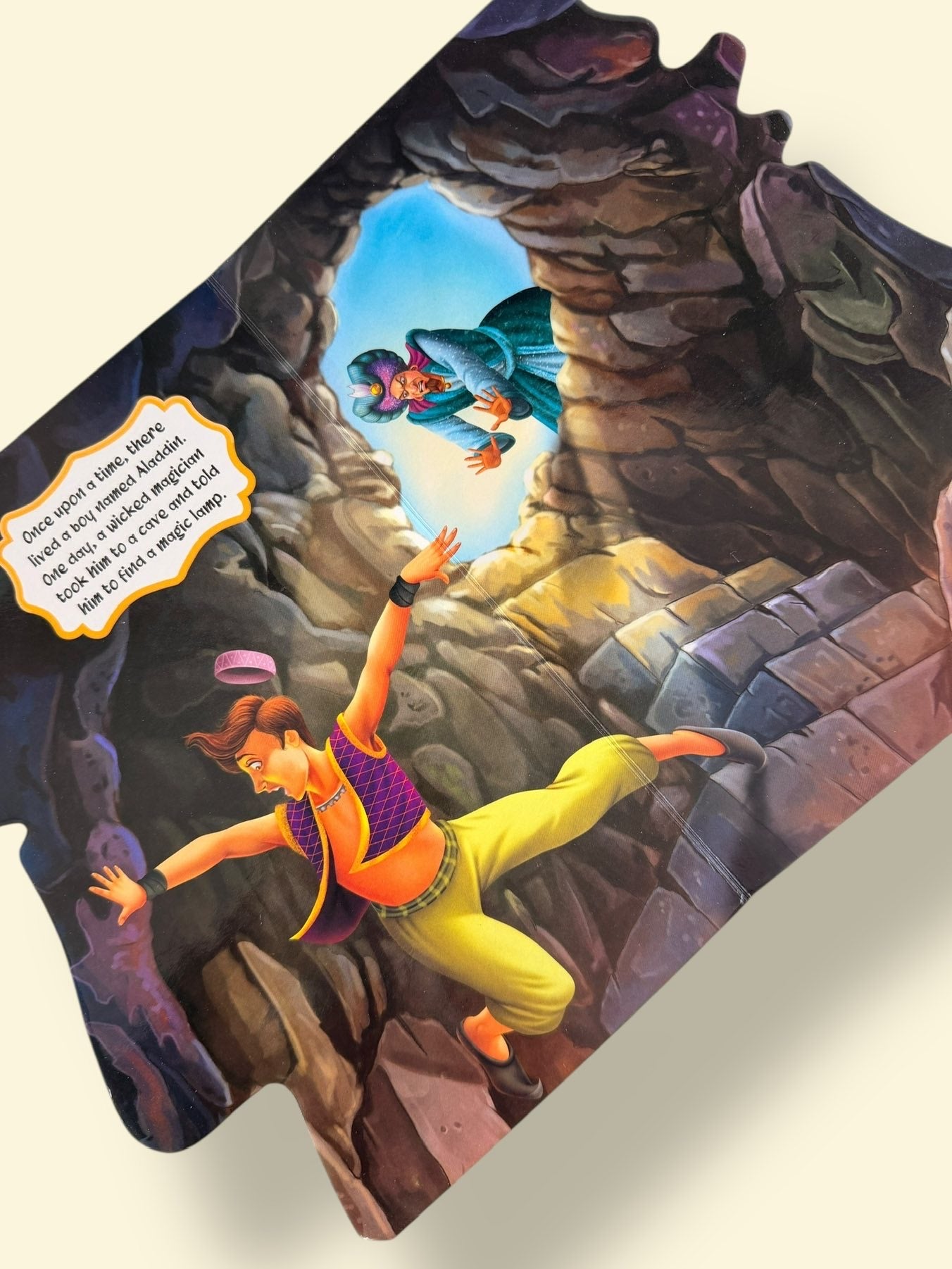 Aladdin Story Board Book page showing Aladdin discovering the magical lamp inside the mysterious cave with colourful illustrations