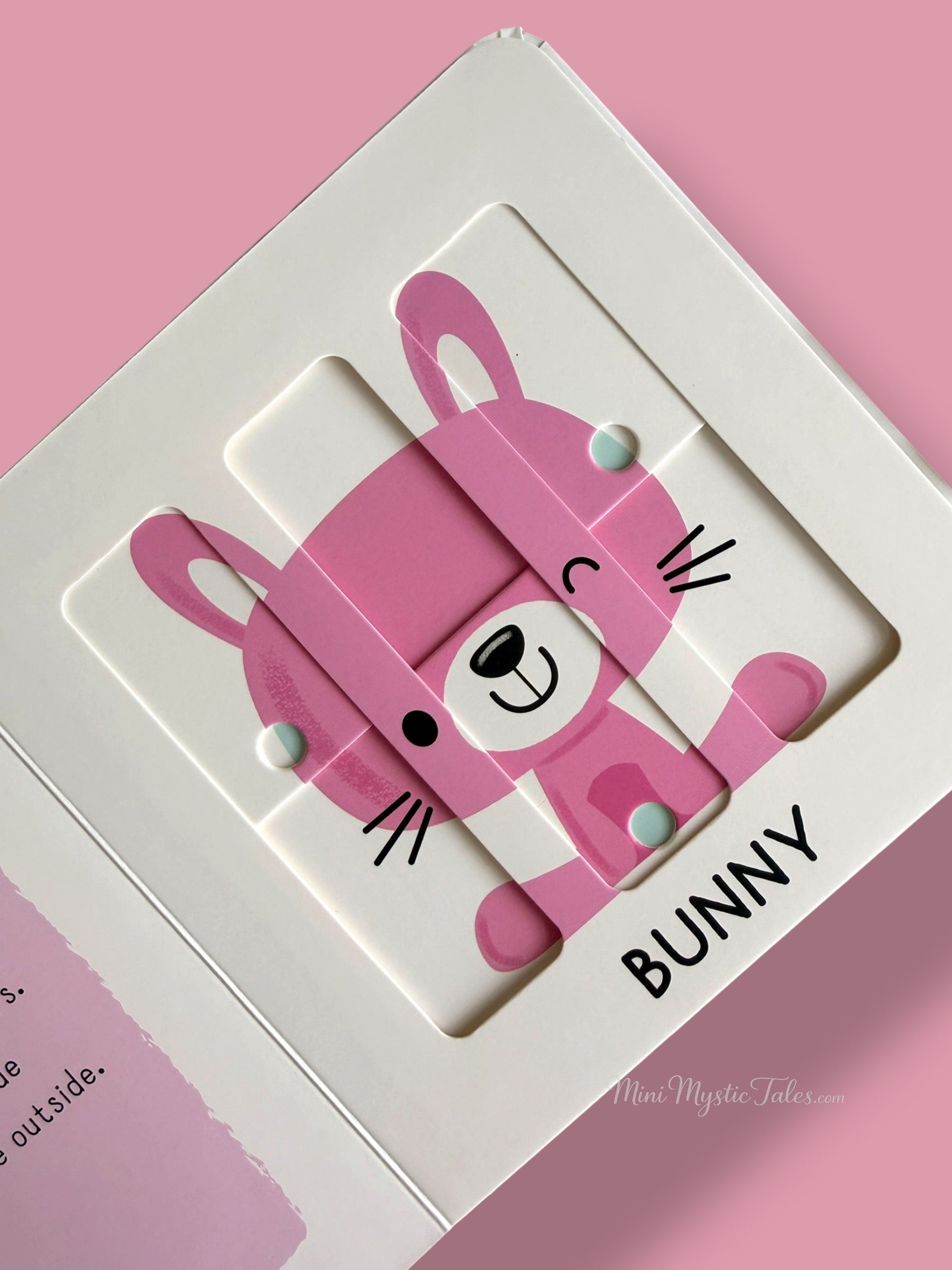 Completed bunny puzzle featuring a smiling pink rabbit in a toddler-friendly board book