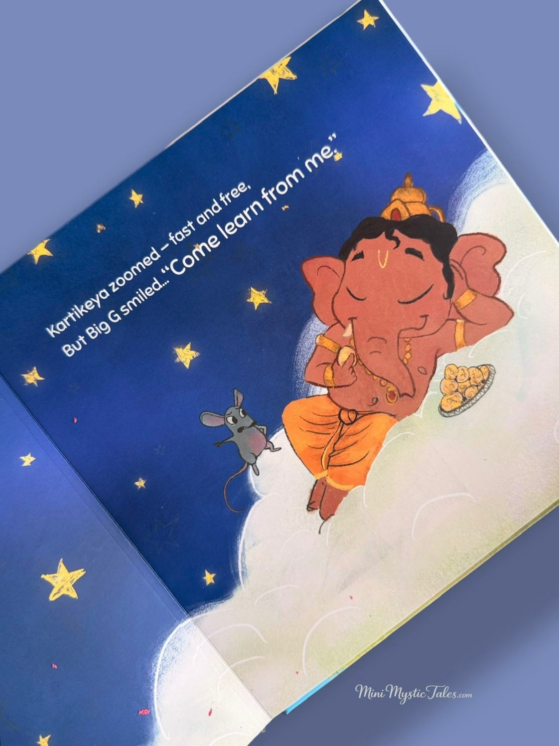 Big G relaxing among the clouds in The Obstacle Crusher, a colourful illustrated story inspired by Lord Ganesha.
