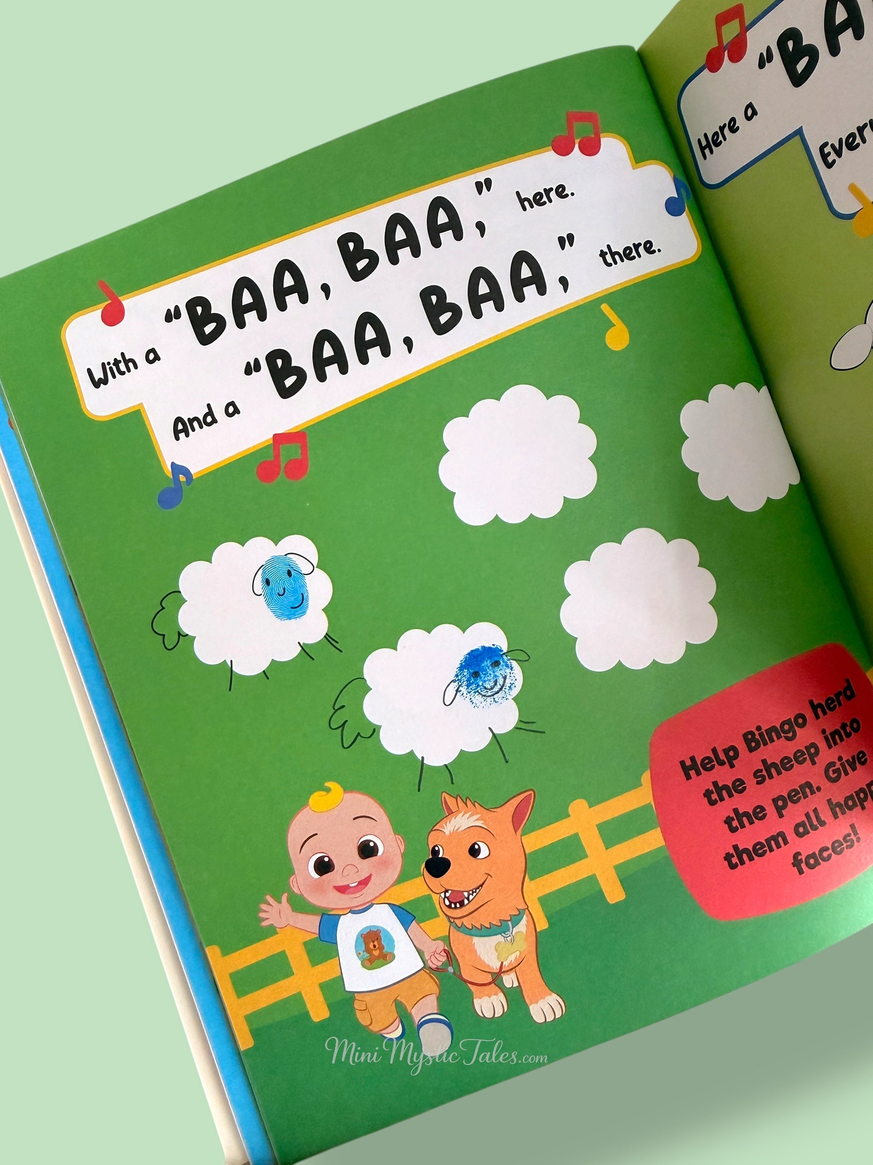 Completed Cocomelon sheep fingerprint activity page with colourful sheep faces