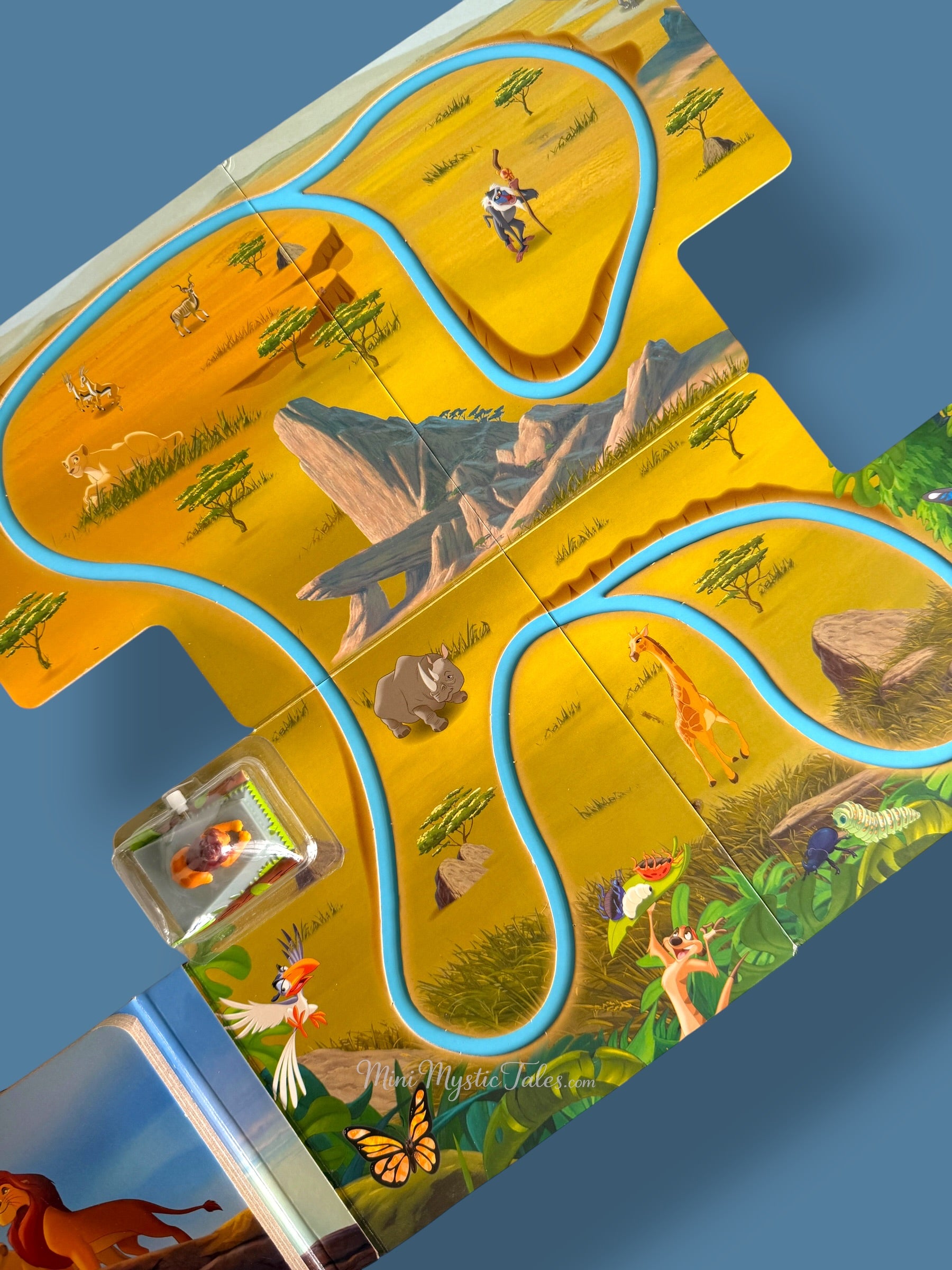 Fold-out Lion King play track featuring winding safari paths, Disney characters, and a wind-up Simba toy