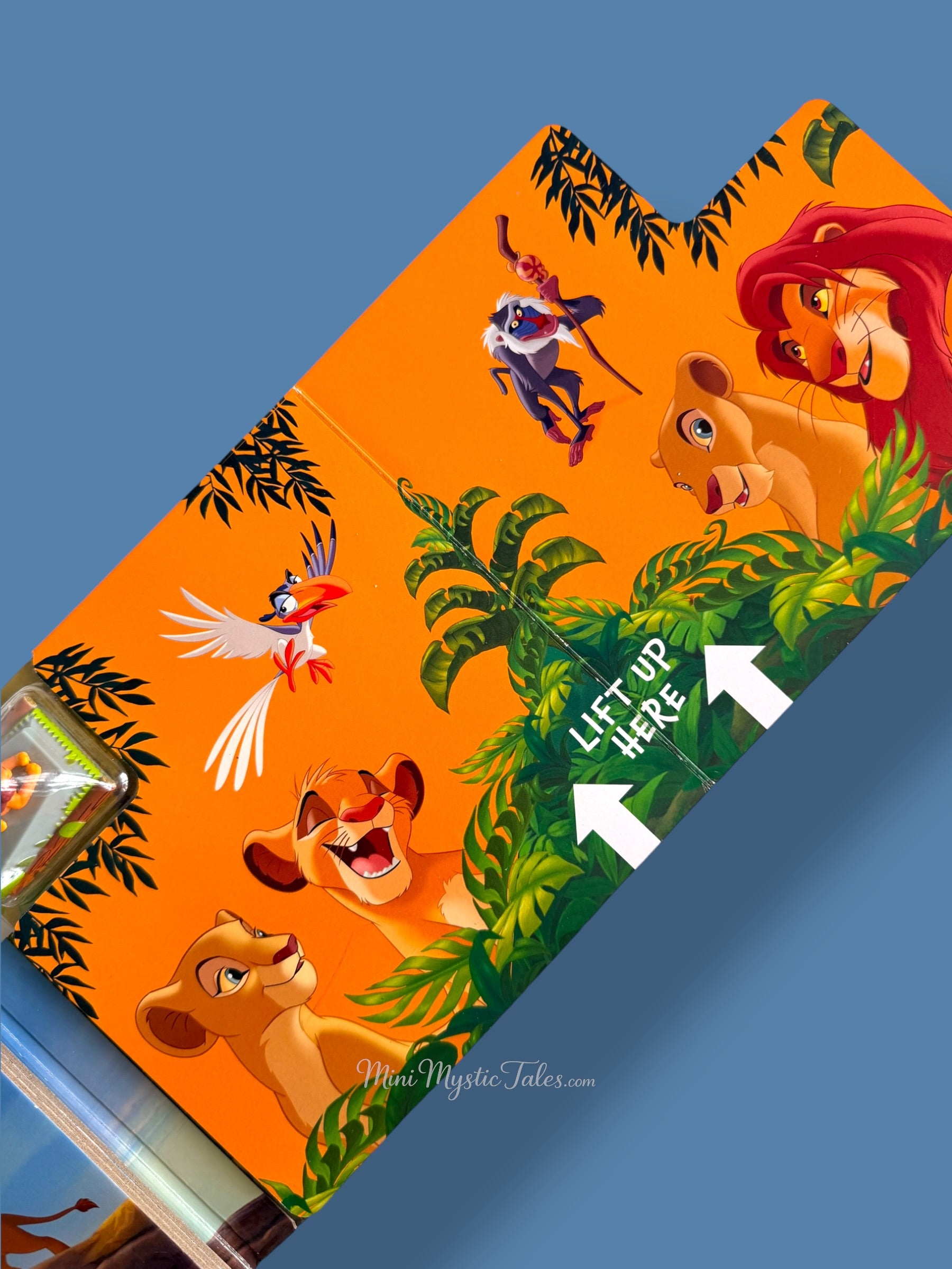 Interactive Lion King play track with Simba wind-up toy, jungle illustrations, and character artwork from the movie