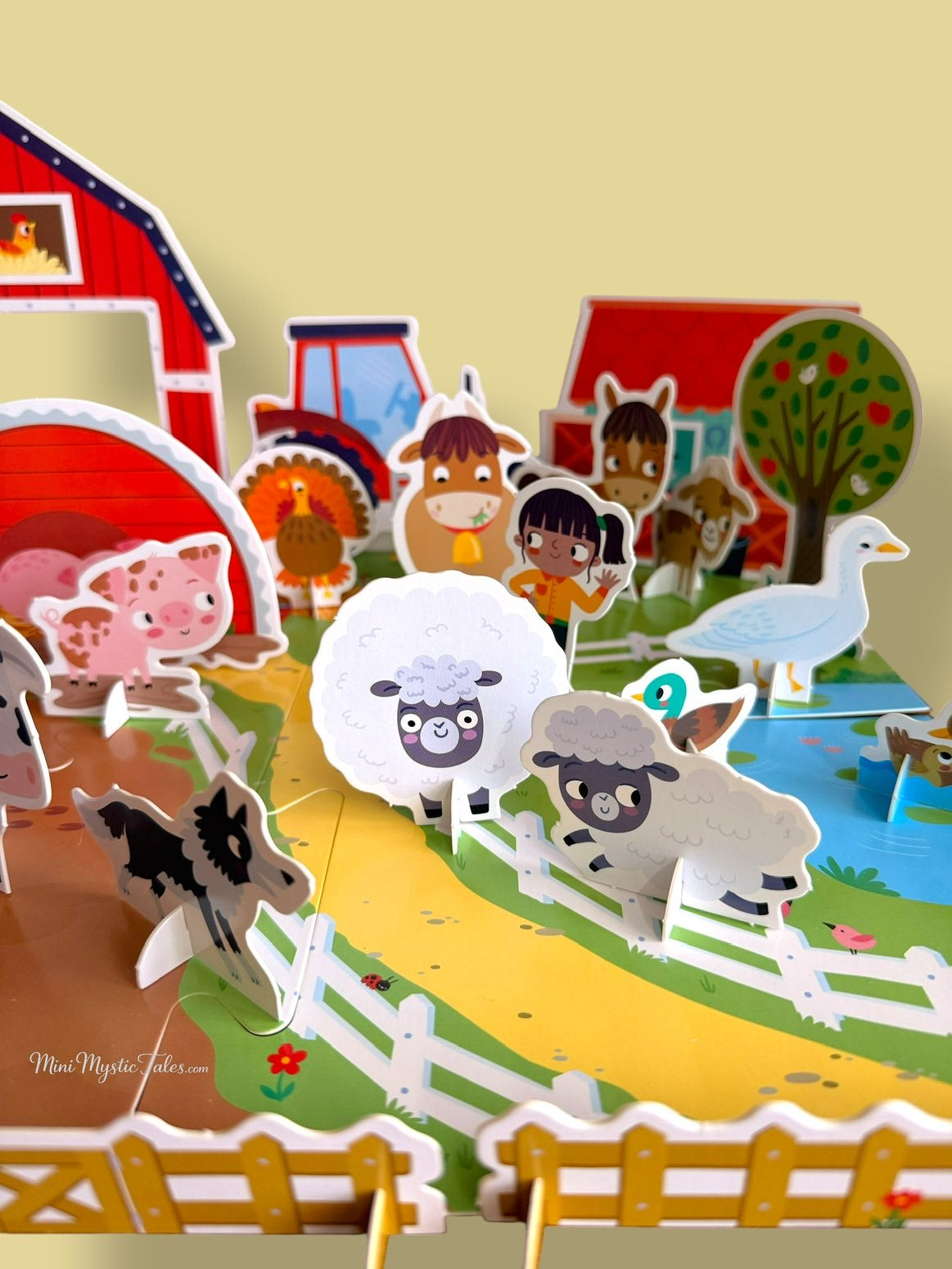 Interactive farm play mat with stand-up animal models, fences, farm buildings and tractor for imaginative play.
