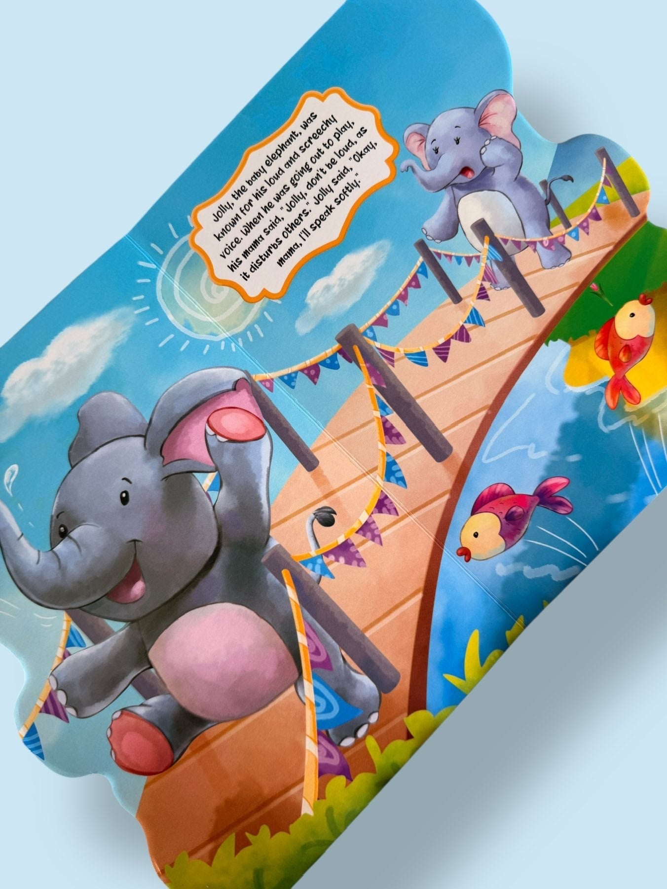 Jolly the Mischievous Elephant Story Board Book page showing Jolly playing loudly on a bridge while learning to be considerate of others