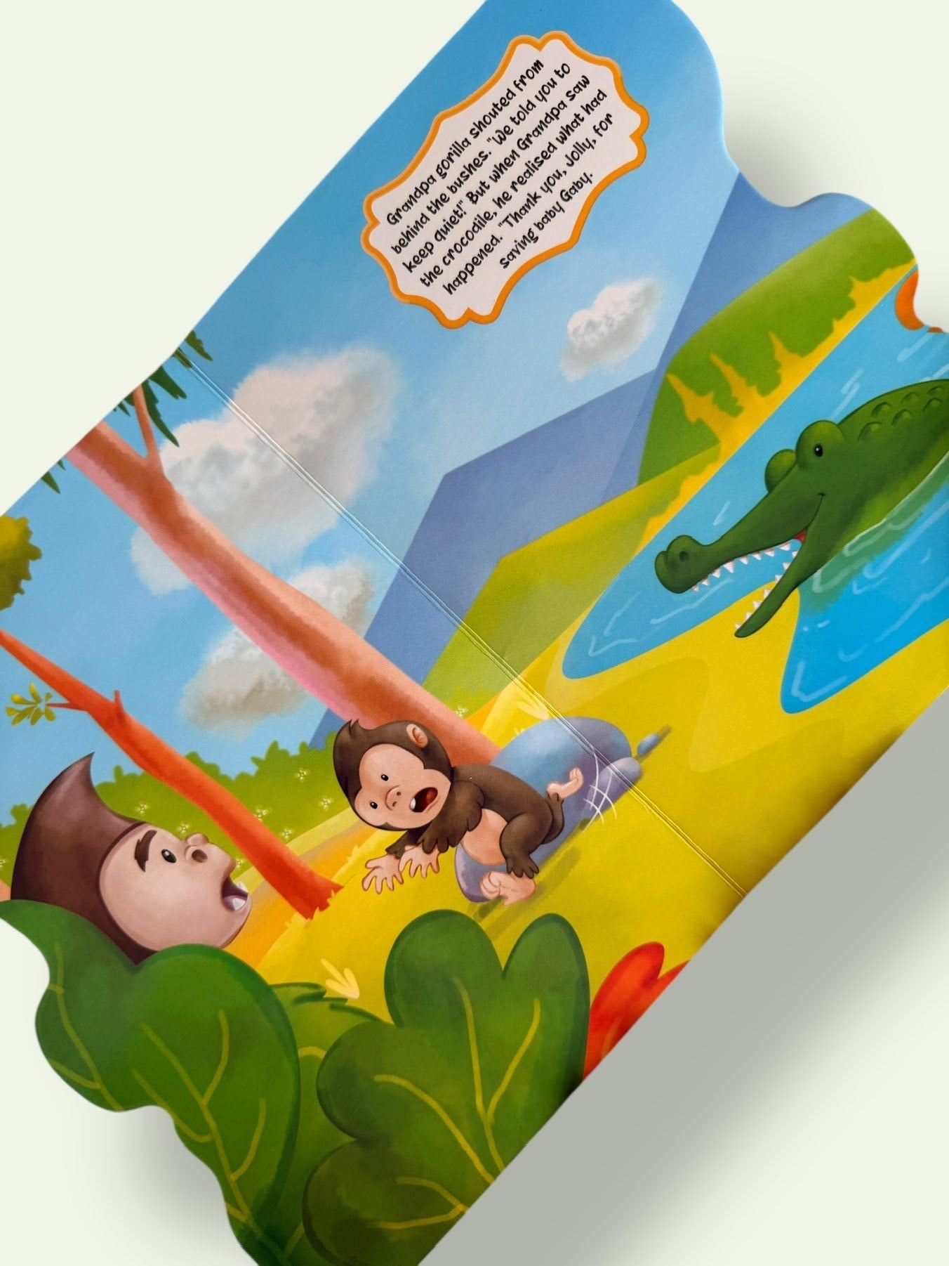 Jolly the Mischievous Elephant Story Board Book page showing the baby gorilla being rescued and Jolly learning the value of listening and kindness