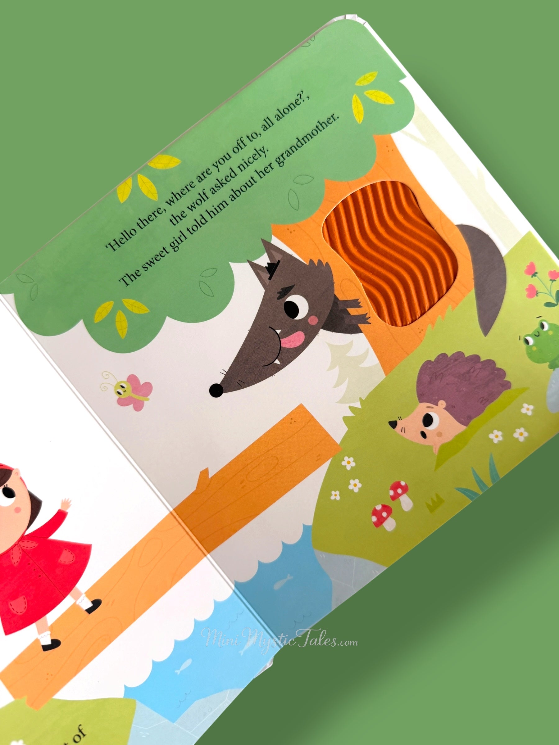 Inside Little Red Riding Hood touch and feel book showing the wolf in the forest scene