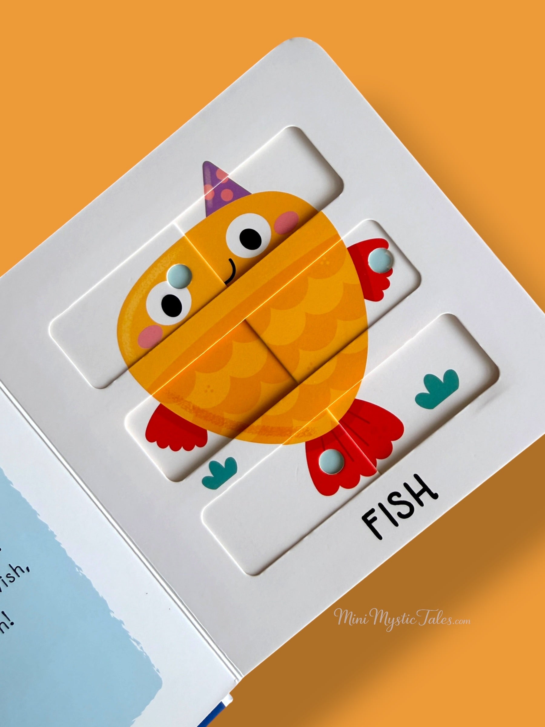 Completed fish sliding puzzle inside an interactive ocean animals board book that builds problem-solving skills