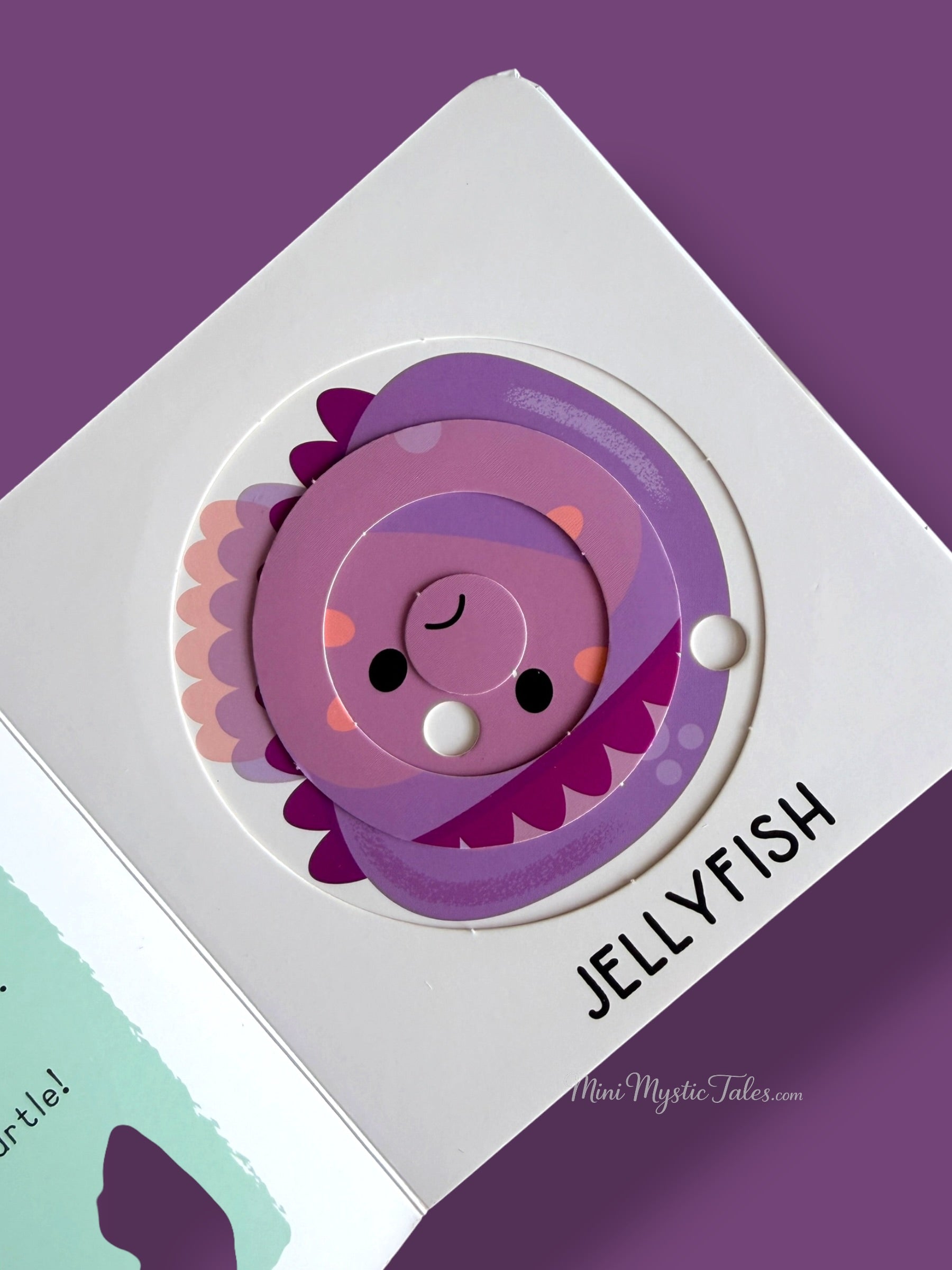 Jellyfish-themed rotating puzzle activity in a toddler learning book about ocean animals