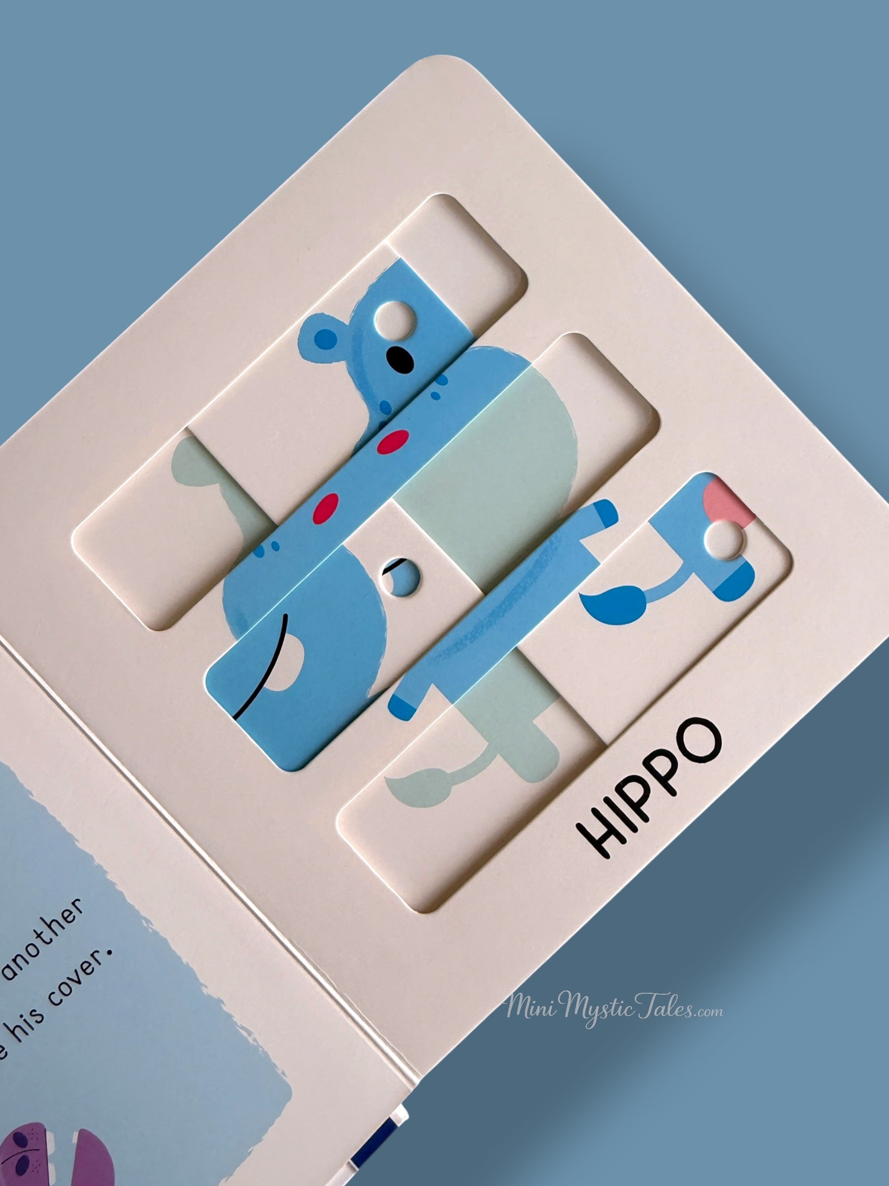 Wild Animals sliding puzzle book page featuring a hippo puzzle challenge for young children