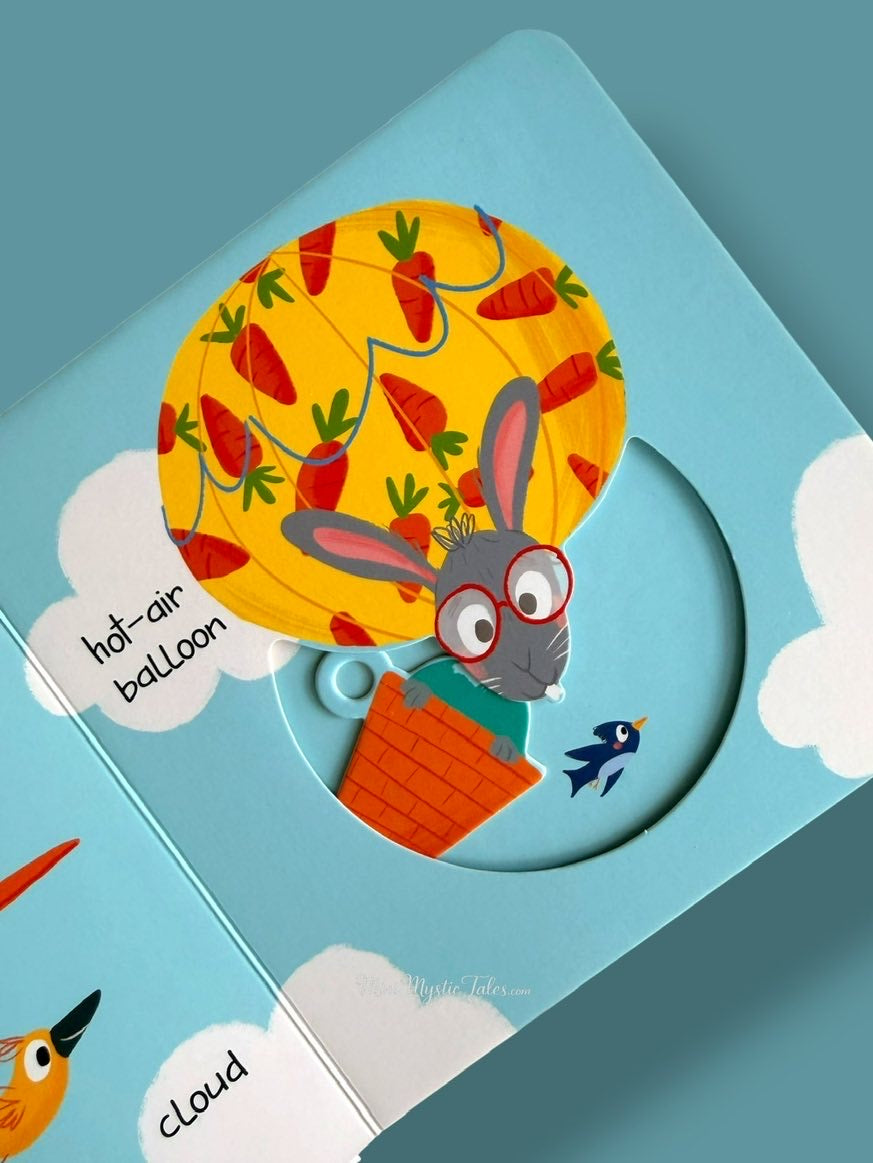 Interactive Slide and Peek On The Move board book showing a rabbit in a hot-air balloon with a movable wheel activity.