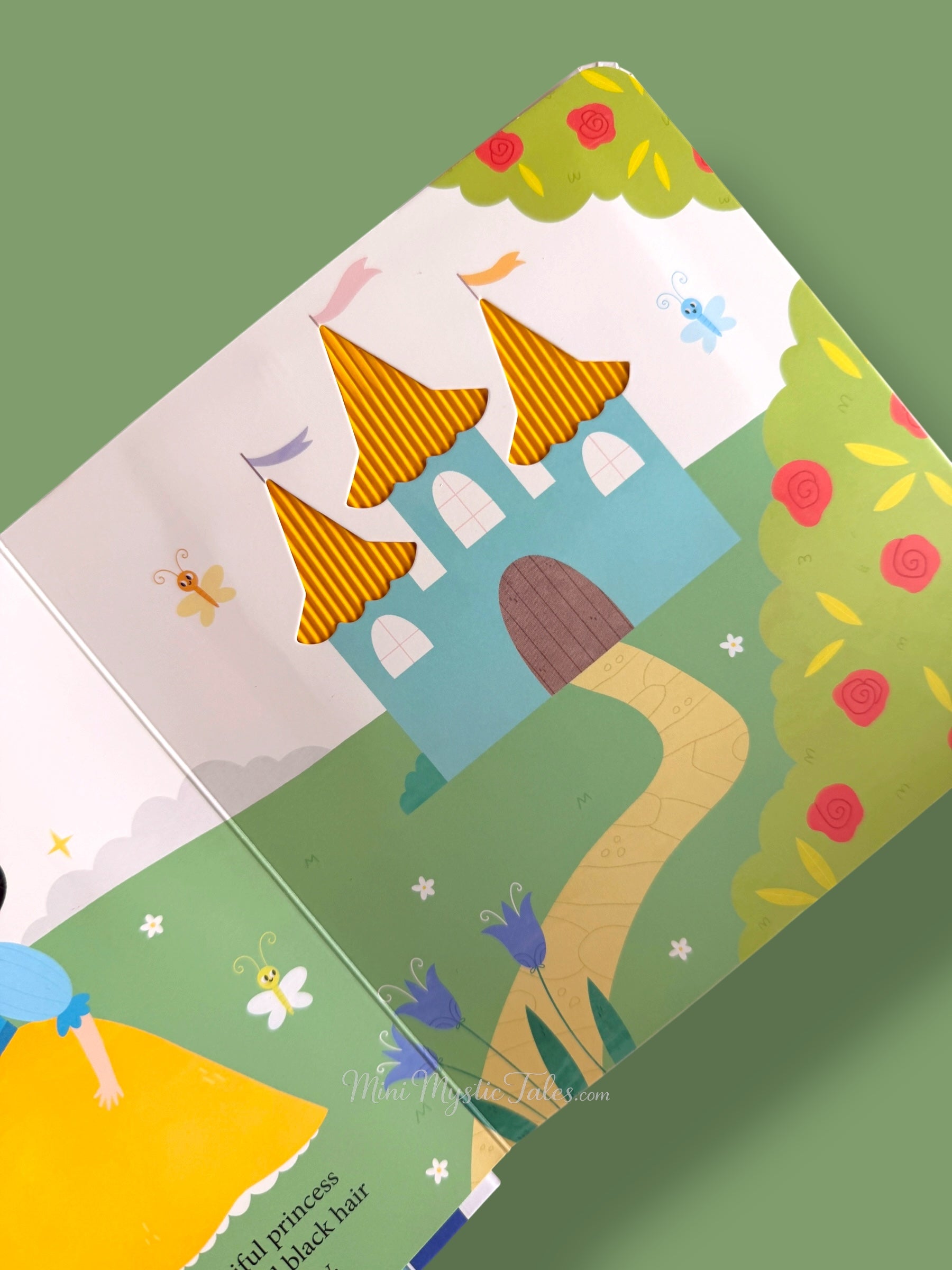 Inside Snow White touch and feel book showing castle scene with textured golden towers