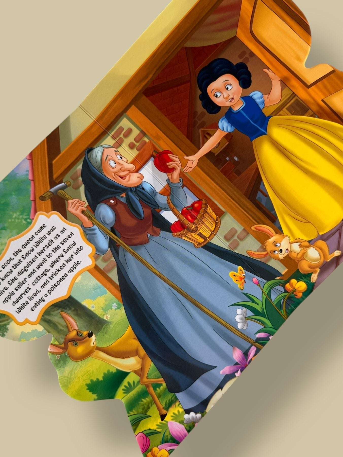 Colourful story pages of Snow White Story Board Book featuring the disguised queen offering the poisoned apple to Snow White