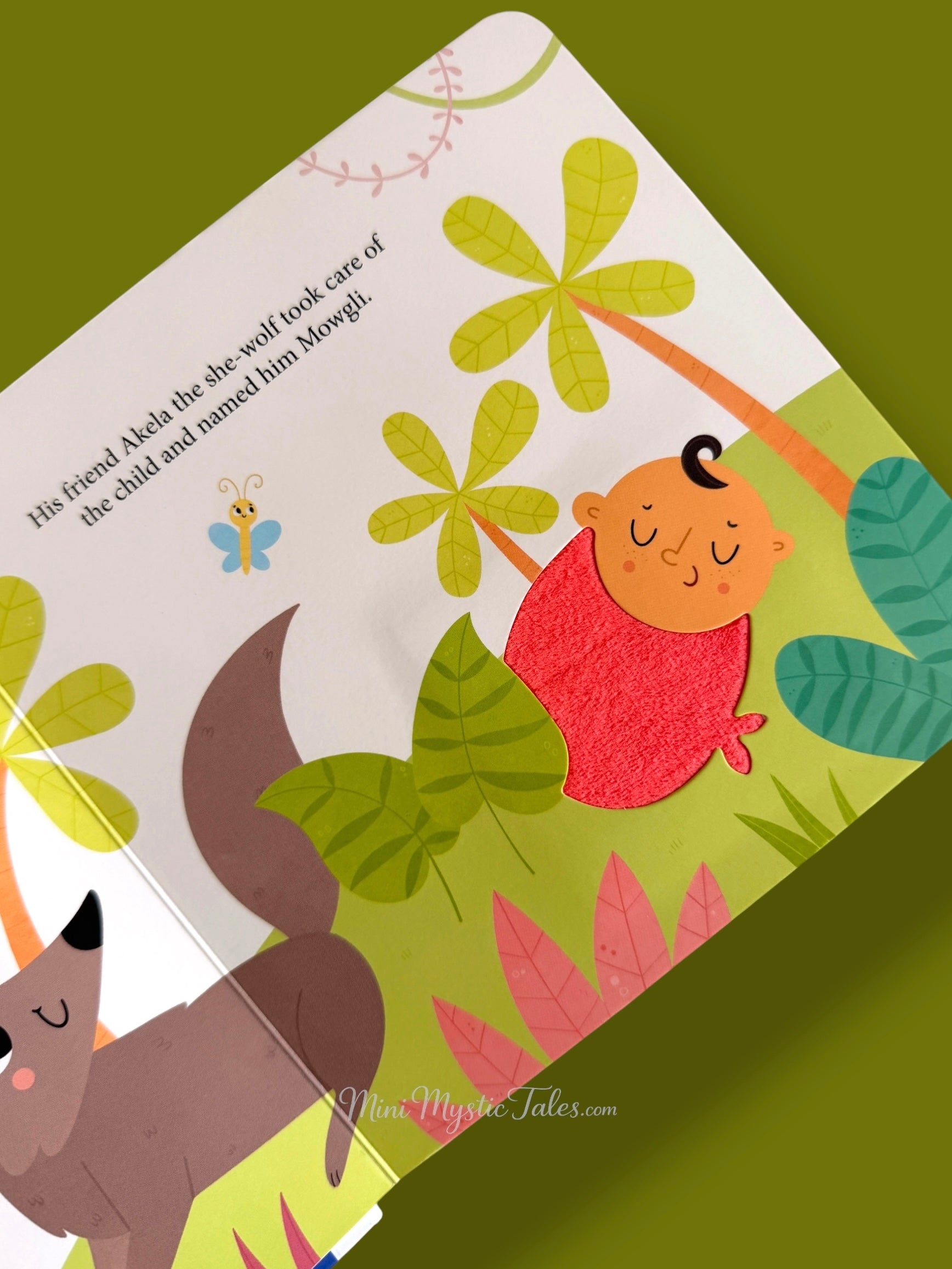 Jungle Book touch and feel story page showing baby Mowgli cared for by wolves in the jungle