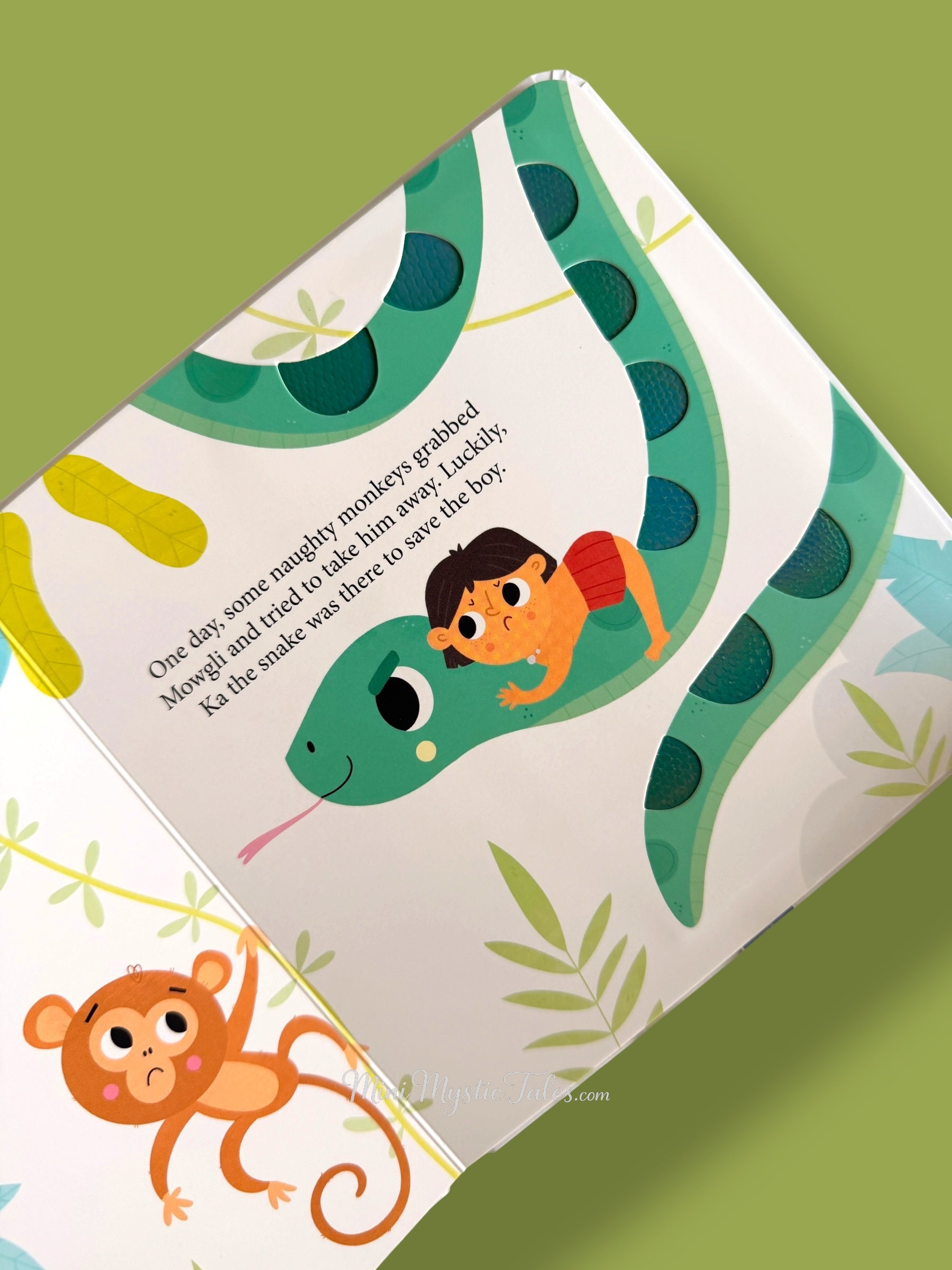 Jungle Book touch and feel page showing Mowgli with a large snake in the jungle