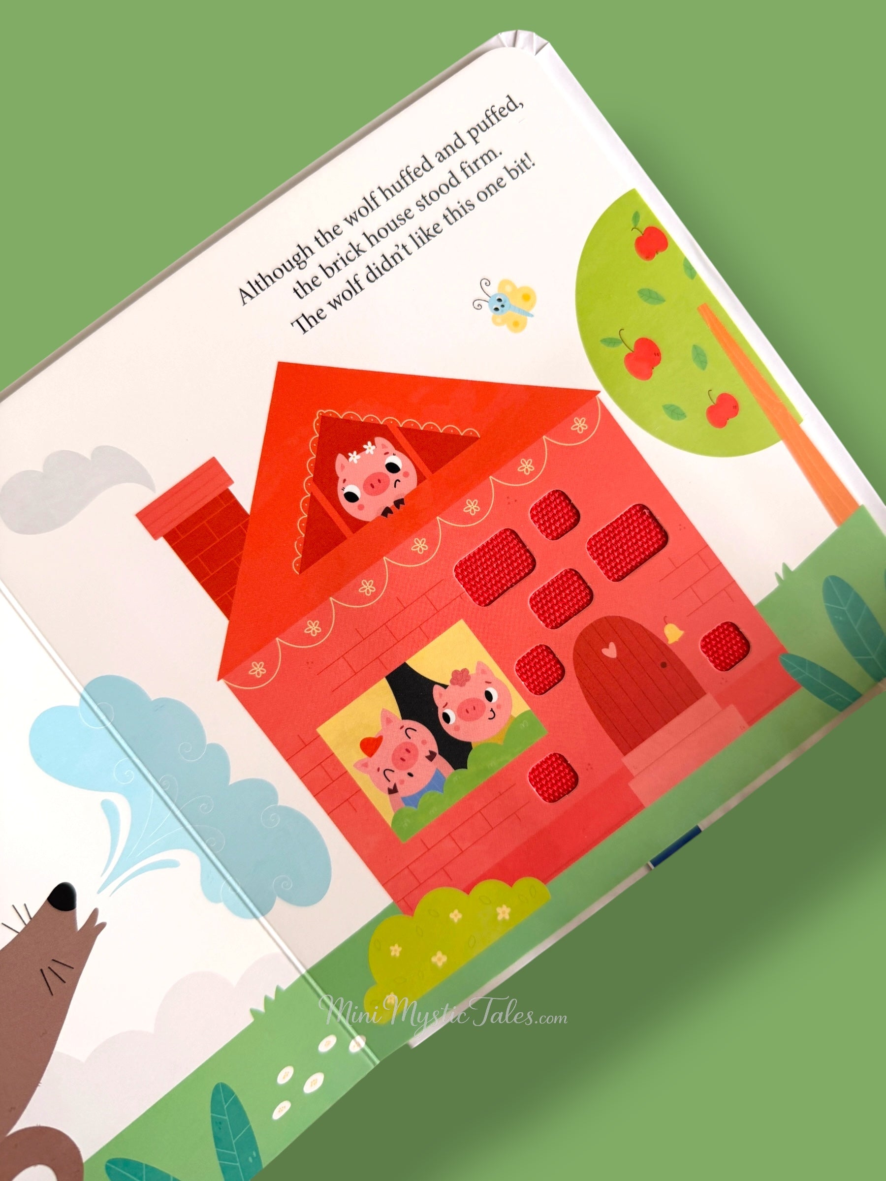 Three Little Pigs touch and feel story page showing brick house with textured windows for toddlers