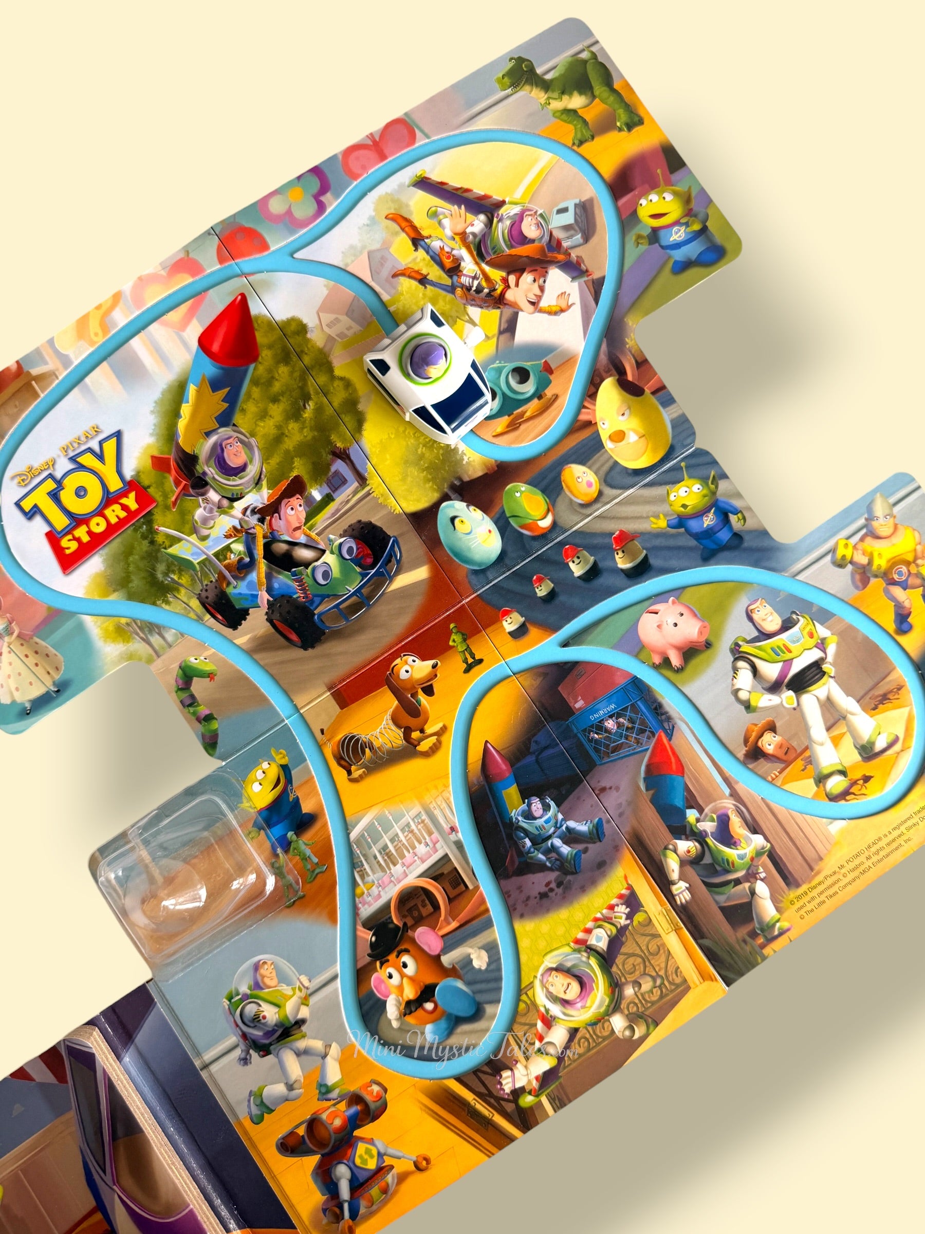 Fold-out Toy Story play track featuring Buzz Lightyear, Woody, Rex, Mr Potato Head and other favourite Pixar characters