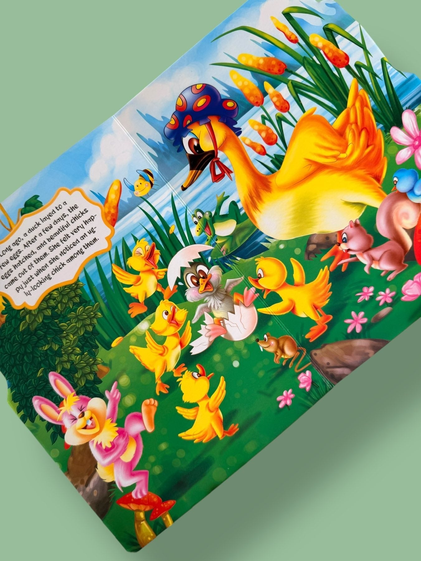 Inside pages of the Ugly Duckling Story Board Book showing the duckling hatching and beginning its journey with vibrant illustrations
